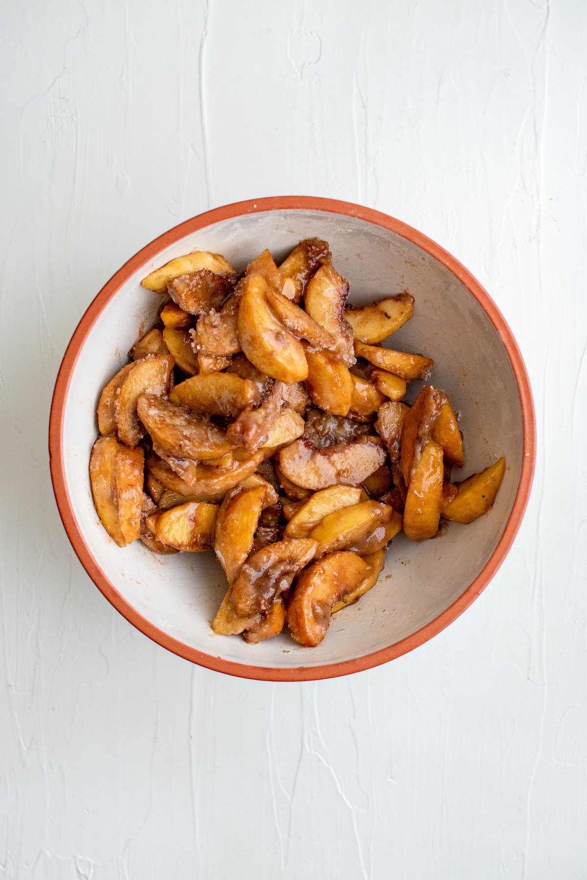 Peach slices coated with flour, sugar, cinnamon, and cornstarch.