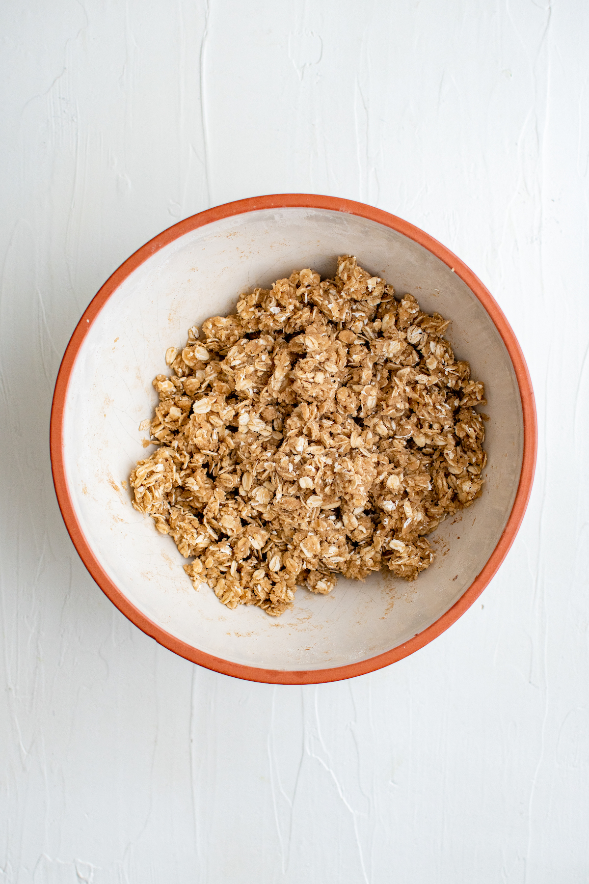 A bowl of uncooked oat topping.
