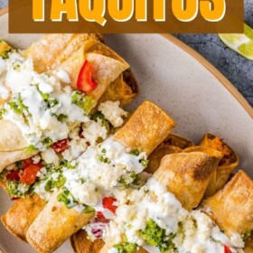 Chicken Taquitos on a plate with sour cream and salsa on top.