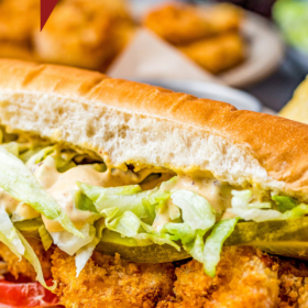 Shrimp po Boy Sandwich with a bite taken out of it.