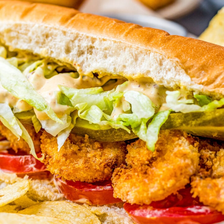 A shrimp sandwich with lettuce and tomato.