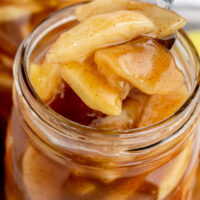 An open mason jar filled with apple pie filling.