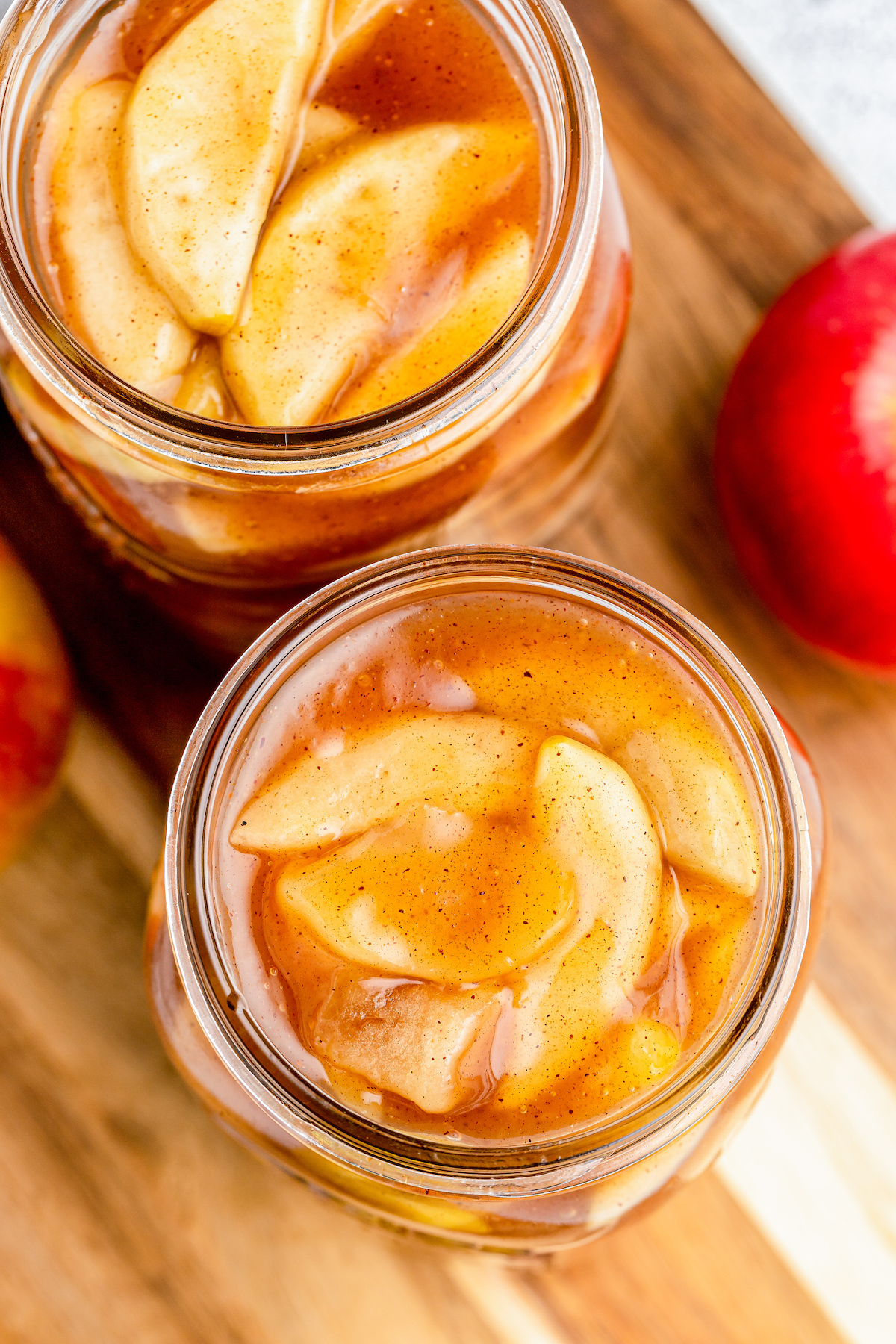 Top view of two open mason jars filled with apple pie filling.