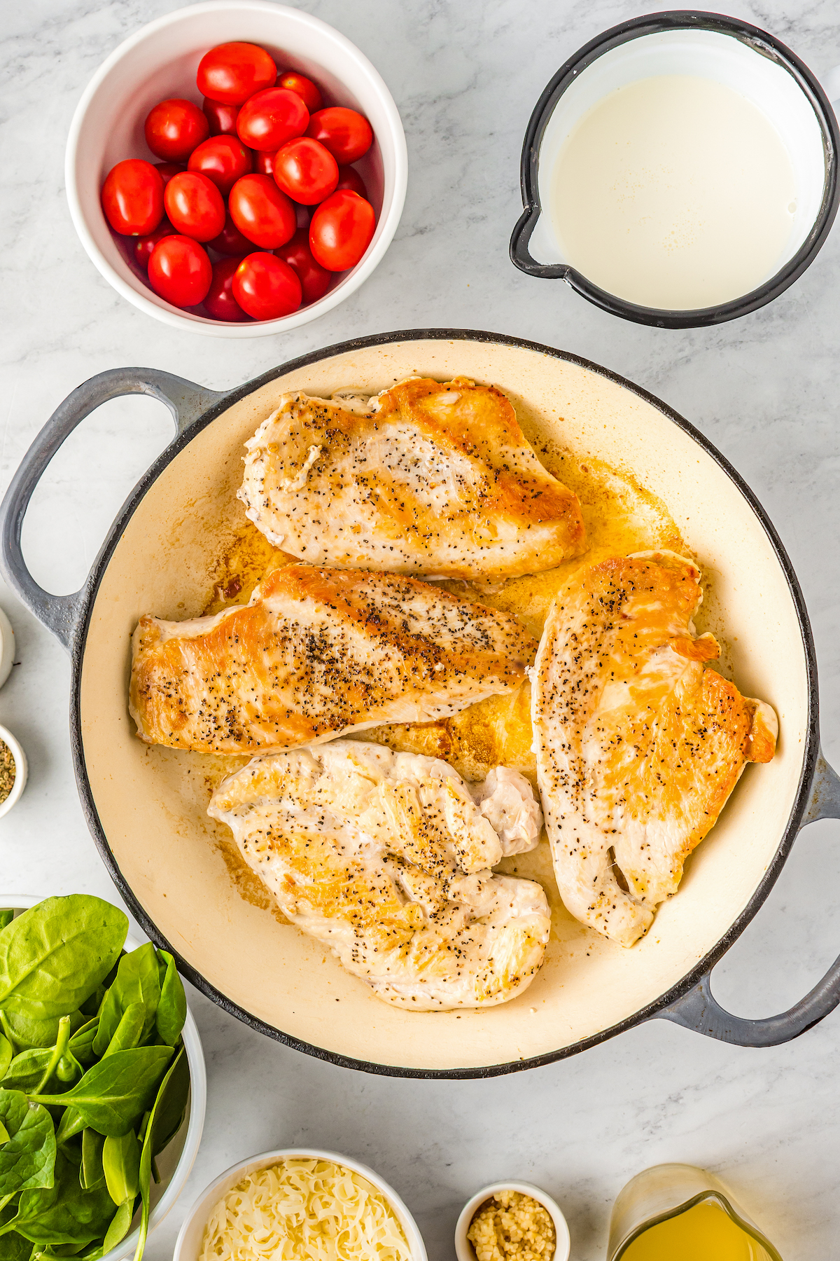 Sauteed chicken breast in a skillet.