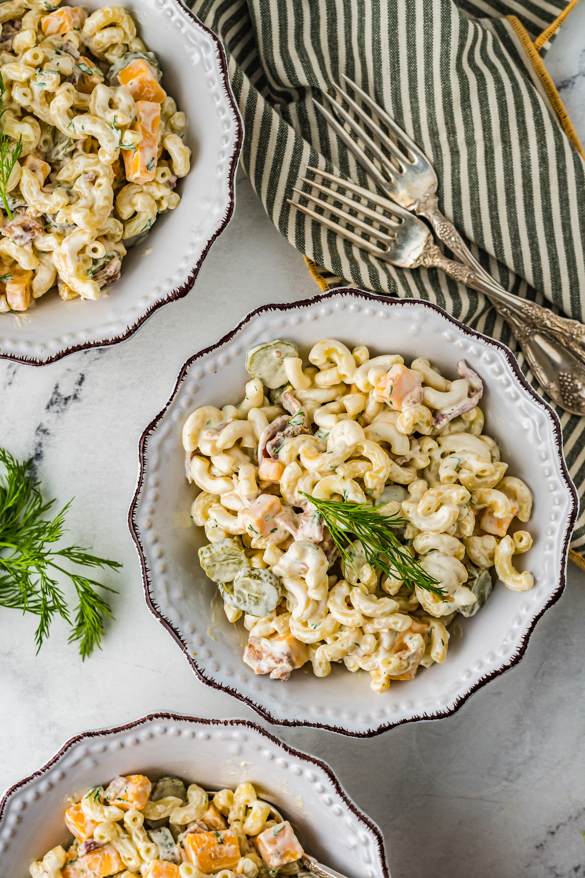 Overhead shot of three bowls of pasta salad.