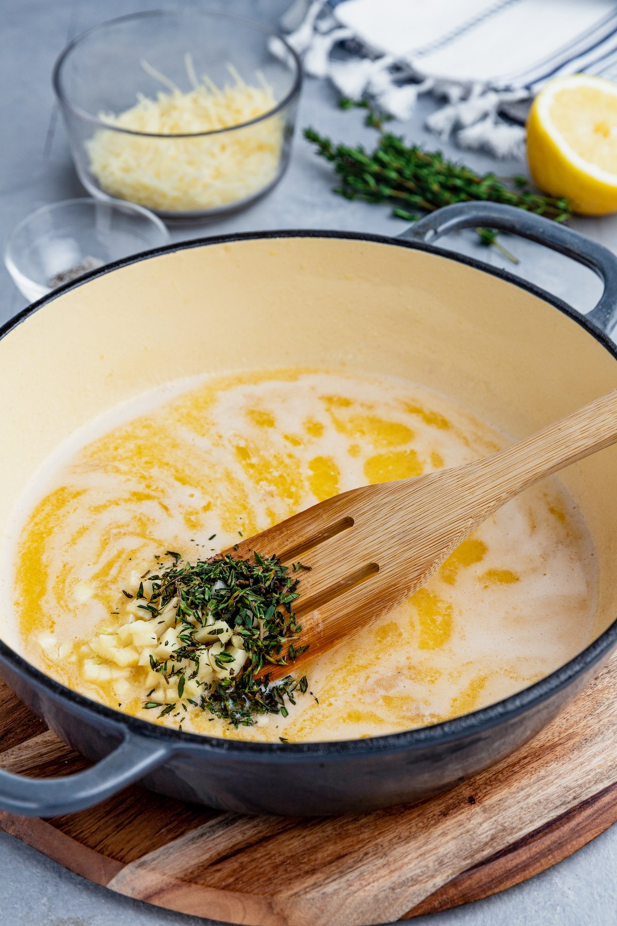 Fresh thyme is added into a skillet with melted butter.