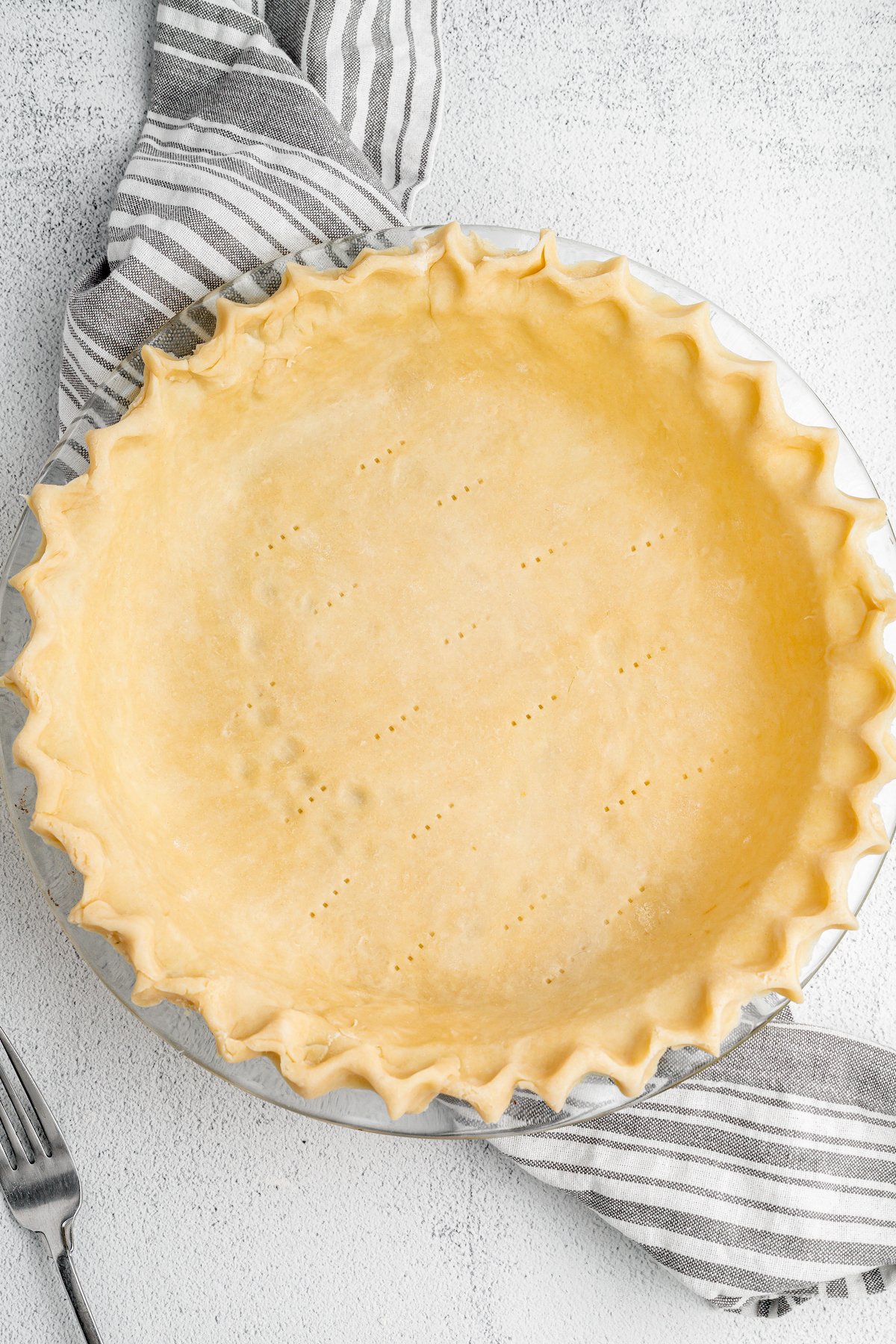 Top view of pie dough inside a pie tin.