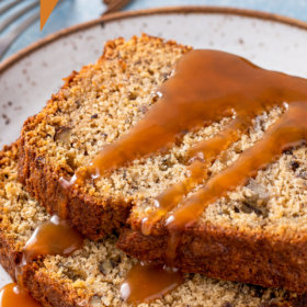 Slices of banana bread being drizzled with caramel.
