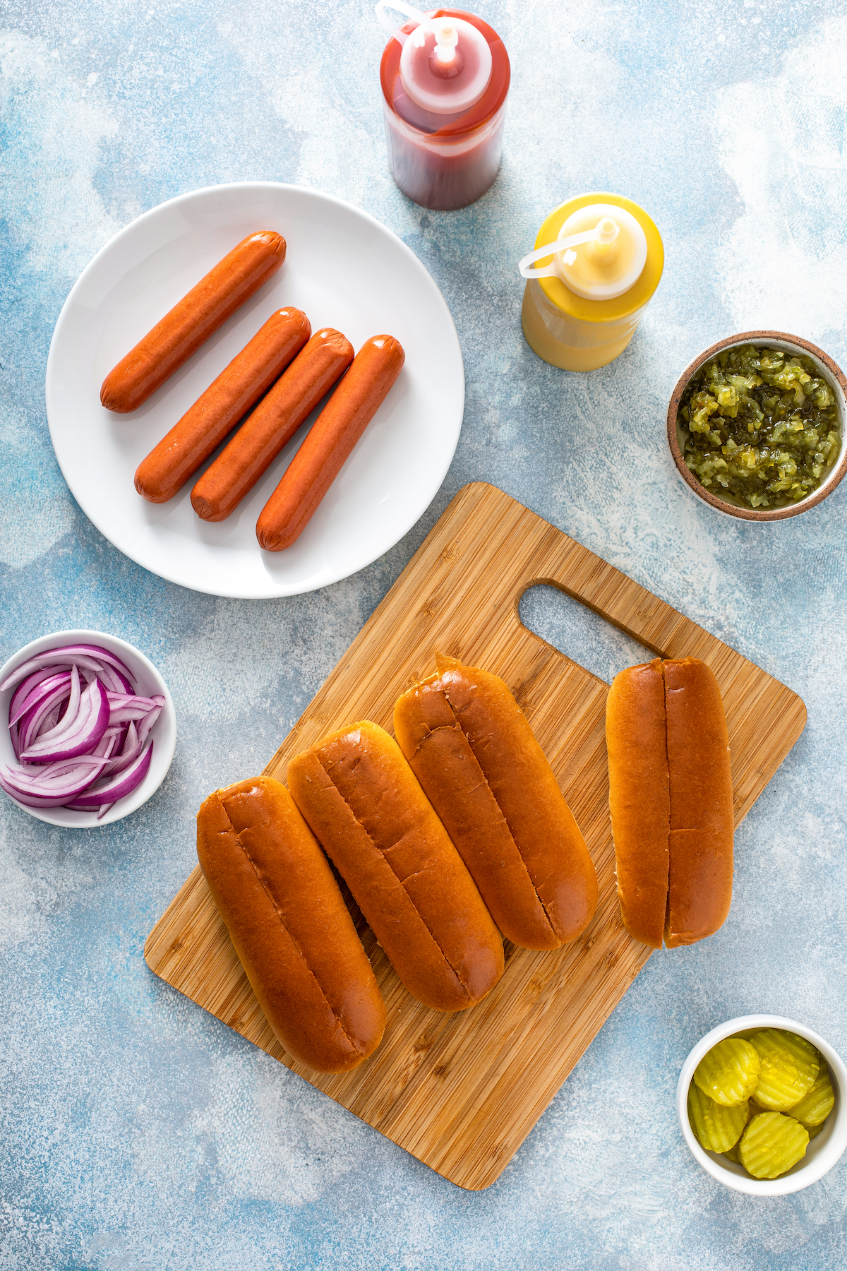 The ingredients for air fryer hot dog buns, including various toppings.