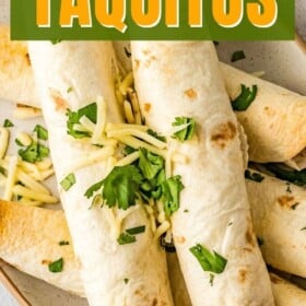Beef taquitos stacked on top of each other on a plate.