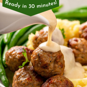 Swedish meatballs being topped with cream sauce.