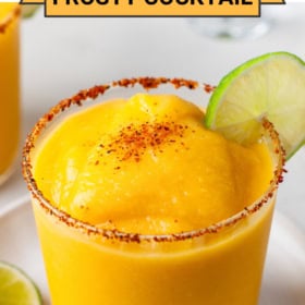 Mango margarita with a lime garnish and tajin.