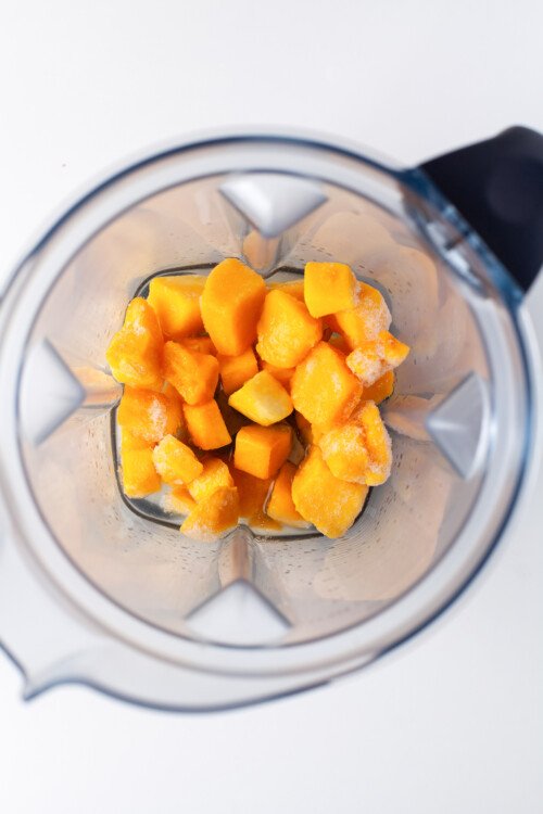Mango chunks in a blender.