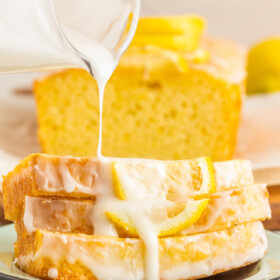 Glaze being poured over a loaf of lemon bread.