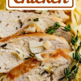 Sliced chicken breasts with lemon and thyme over noodles.