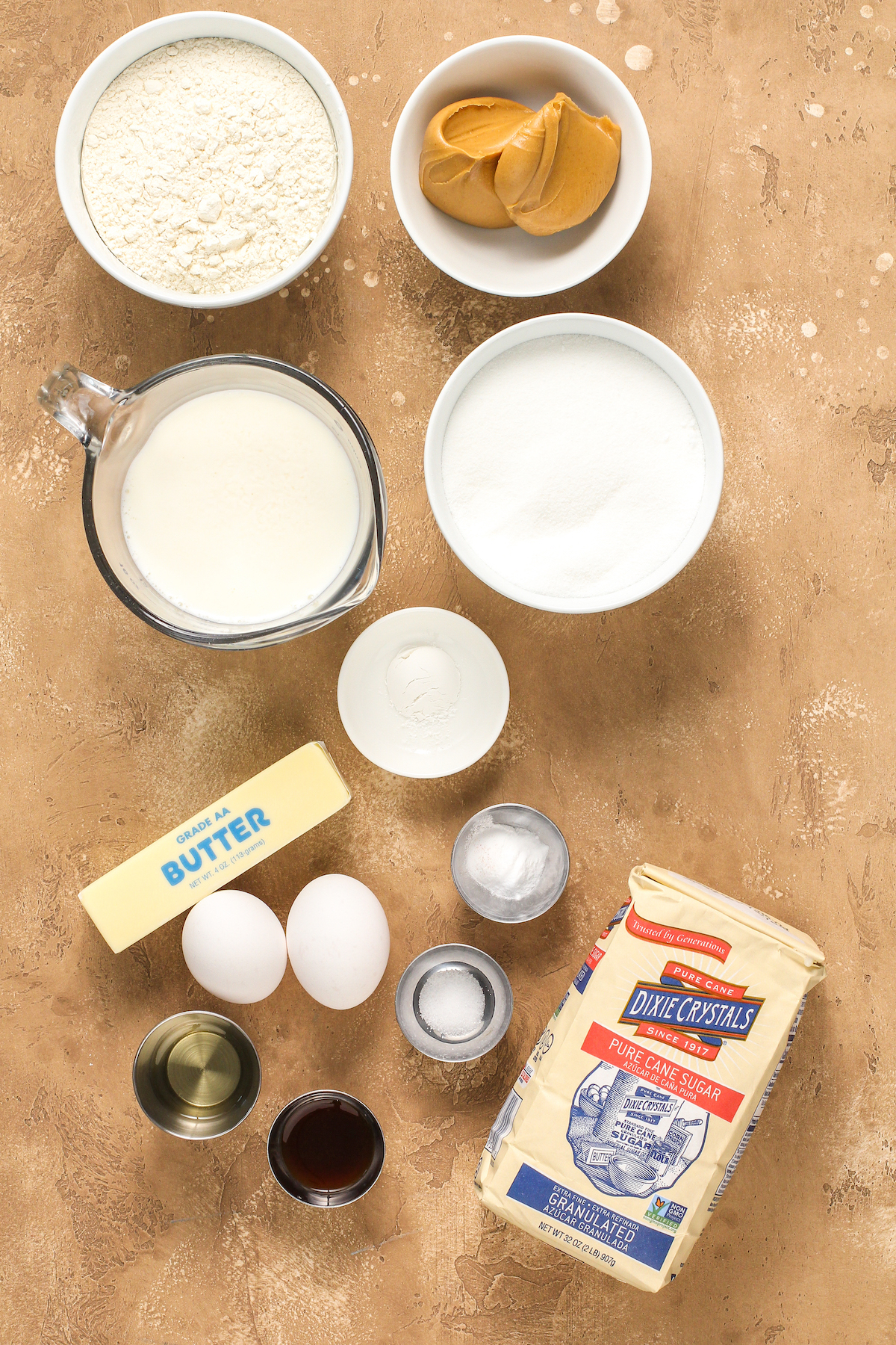 From top left: Flour, peanut butter, buttermilk, sugar, butter, baking powder, eggs, baking soda, vegetable oil, vanilla