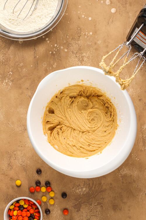 Wet cake ingredients mixed together in a mixing bowl with a hand mixer.