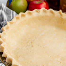 Pie crust in a glass pie dish.