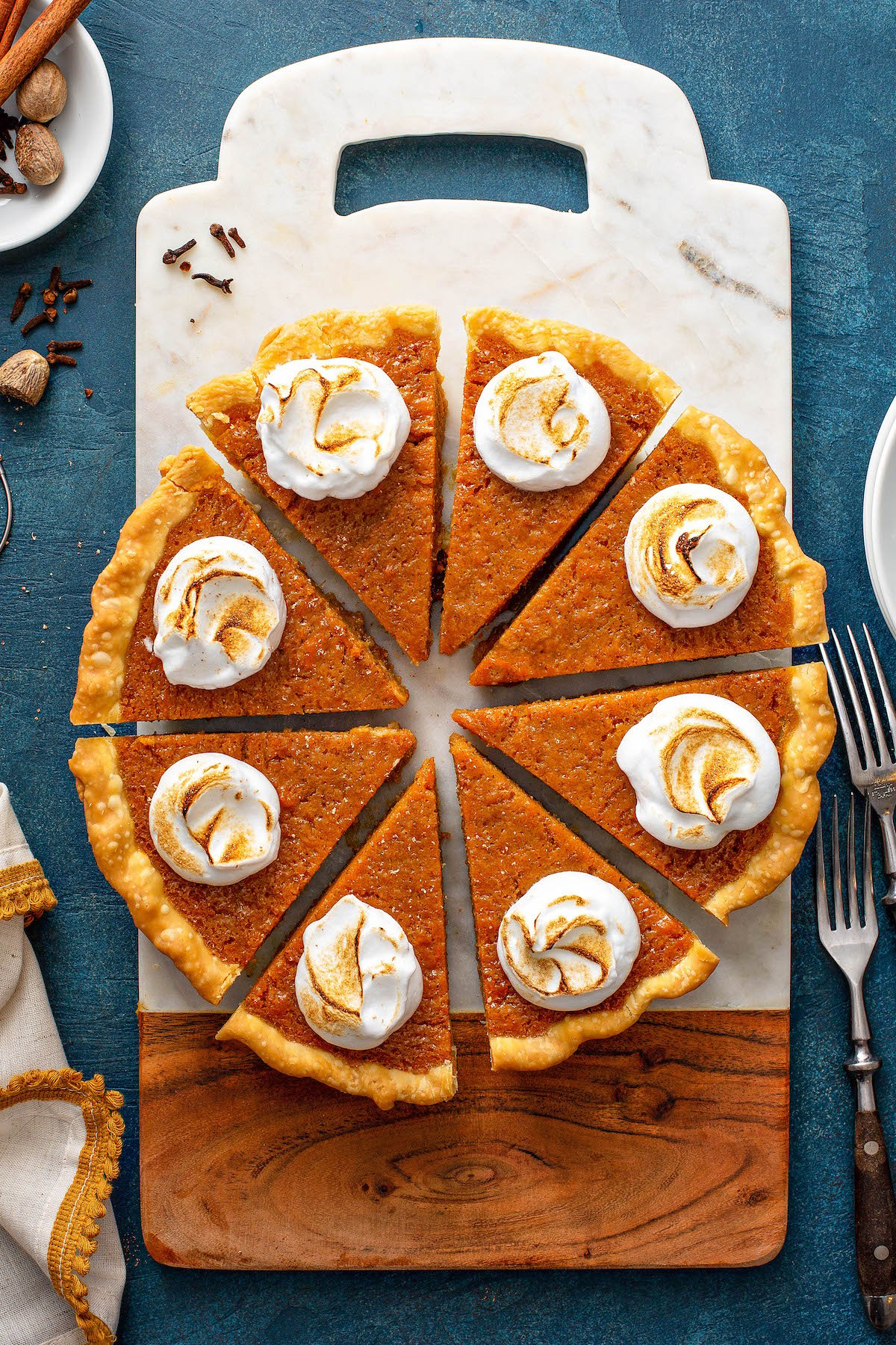 Sweet potato pie sliced into pieces on a cutting board!