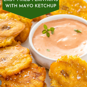 Tostones on a white serving tray with a bowl of mayo ketchup.