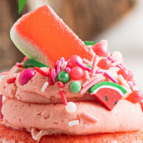 Pink watermelon cupcake with watermelon buttercream and sprinkles.