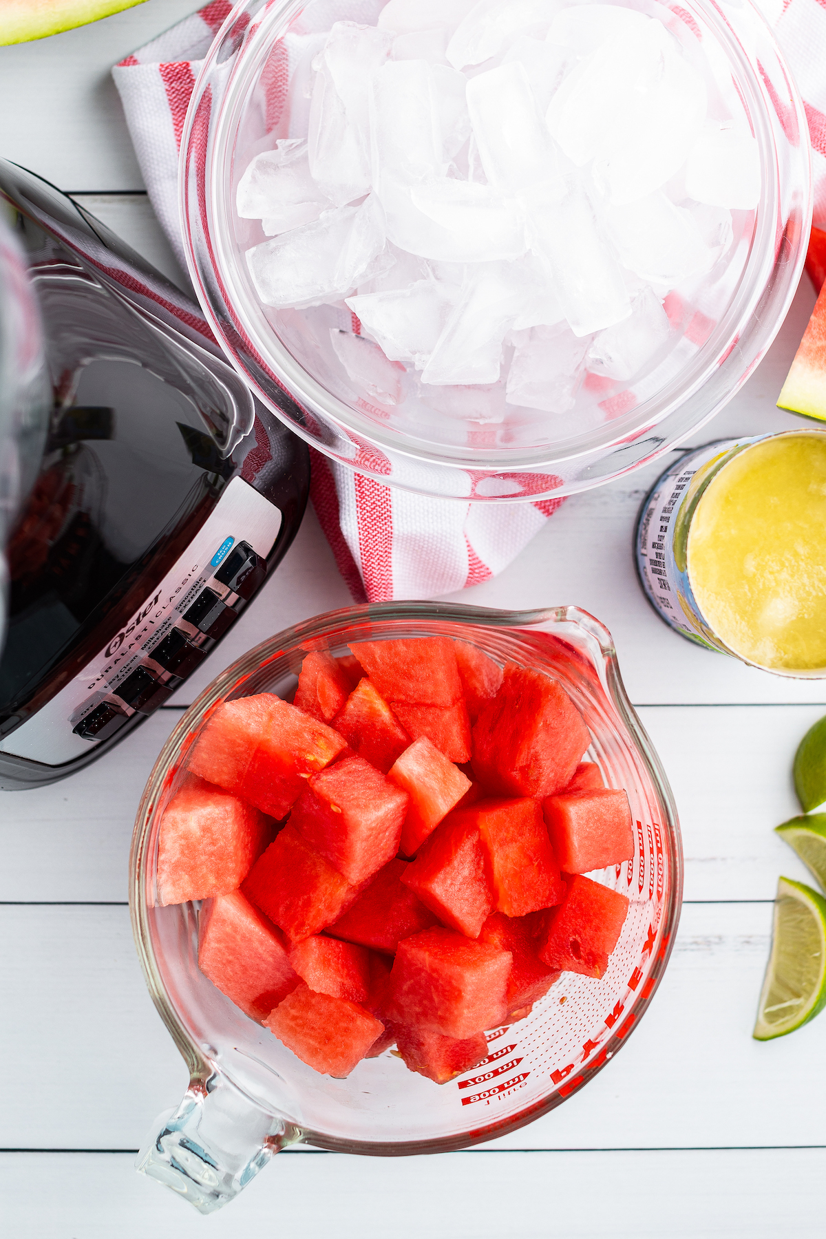 Top view of the ingredients for watermelon limeade slushies next to a blender.