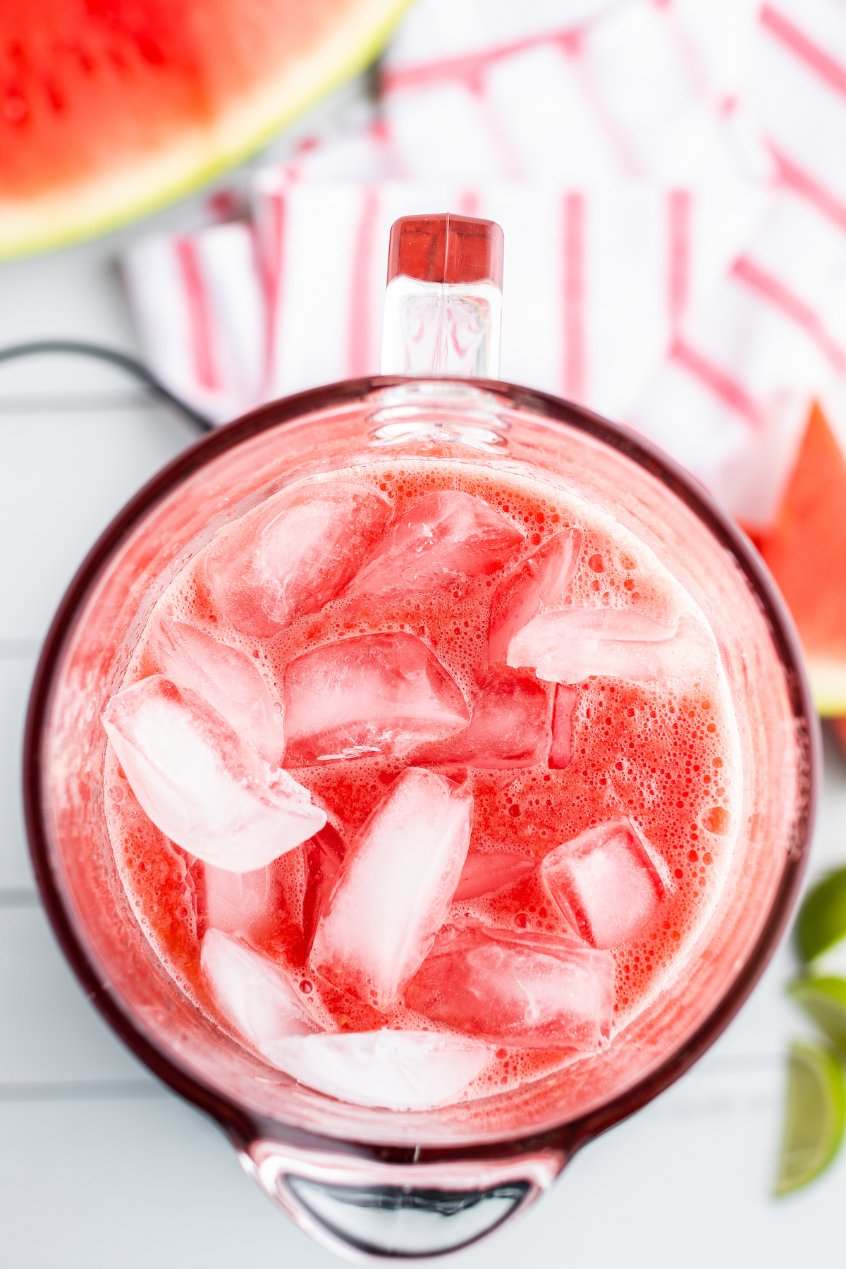 Ice is added into a blender with a watermelon limeade mixture.