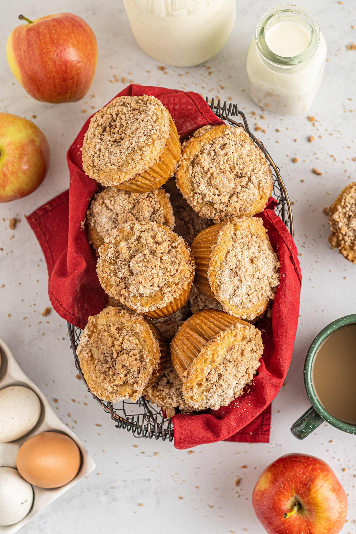 A wire basket filled with apple cinnamon muffins.