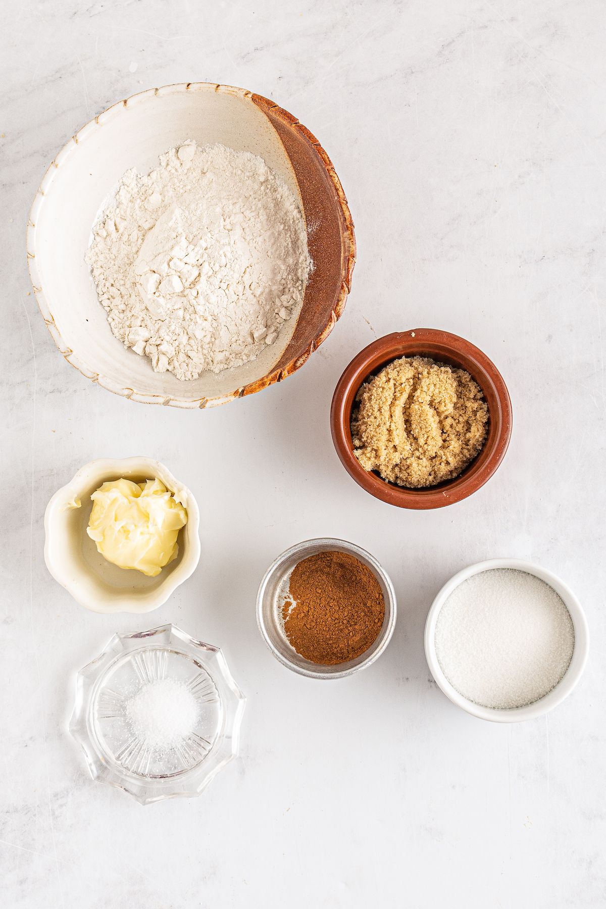 From top left: Flour, brown sugar, butter, cinnamon, granulated sugar, salt.