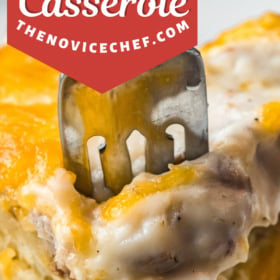 A fork taking a bite of biscuits and gravy casserole.