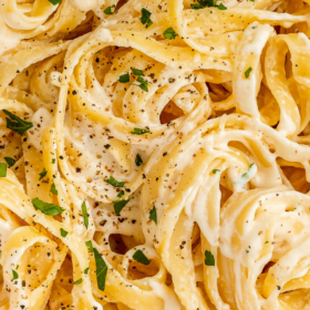 Up close image of Fettuccine Alfredo with Cream Cheese with salt and pepper on top.