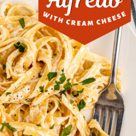 Fettuccine Alfredo with Cream Cheese on a plate with a fork swirling the pasta.