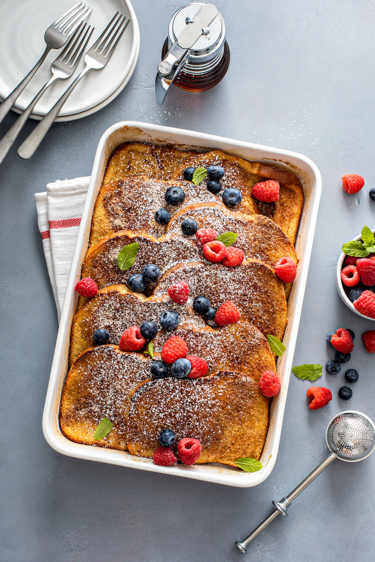 Bake French toast with fresh fruit and syrup.
