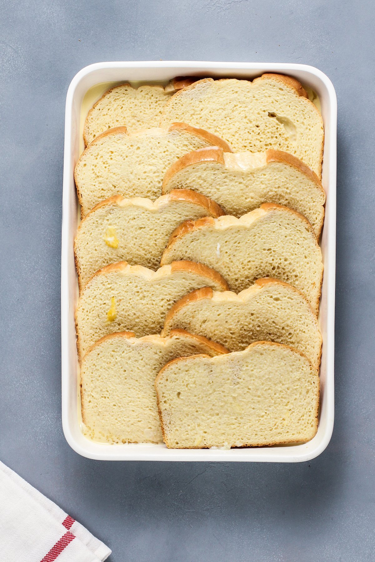 A baking dish of sliced bread that has been soaked in custard mixture.
