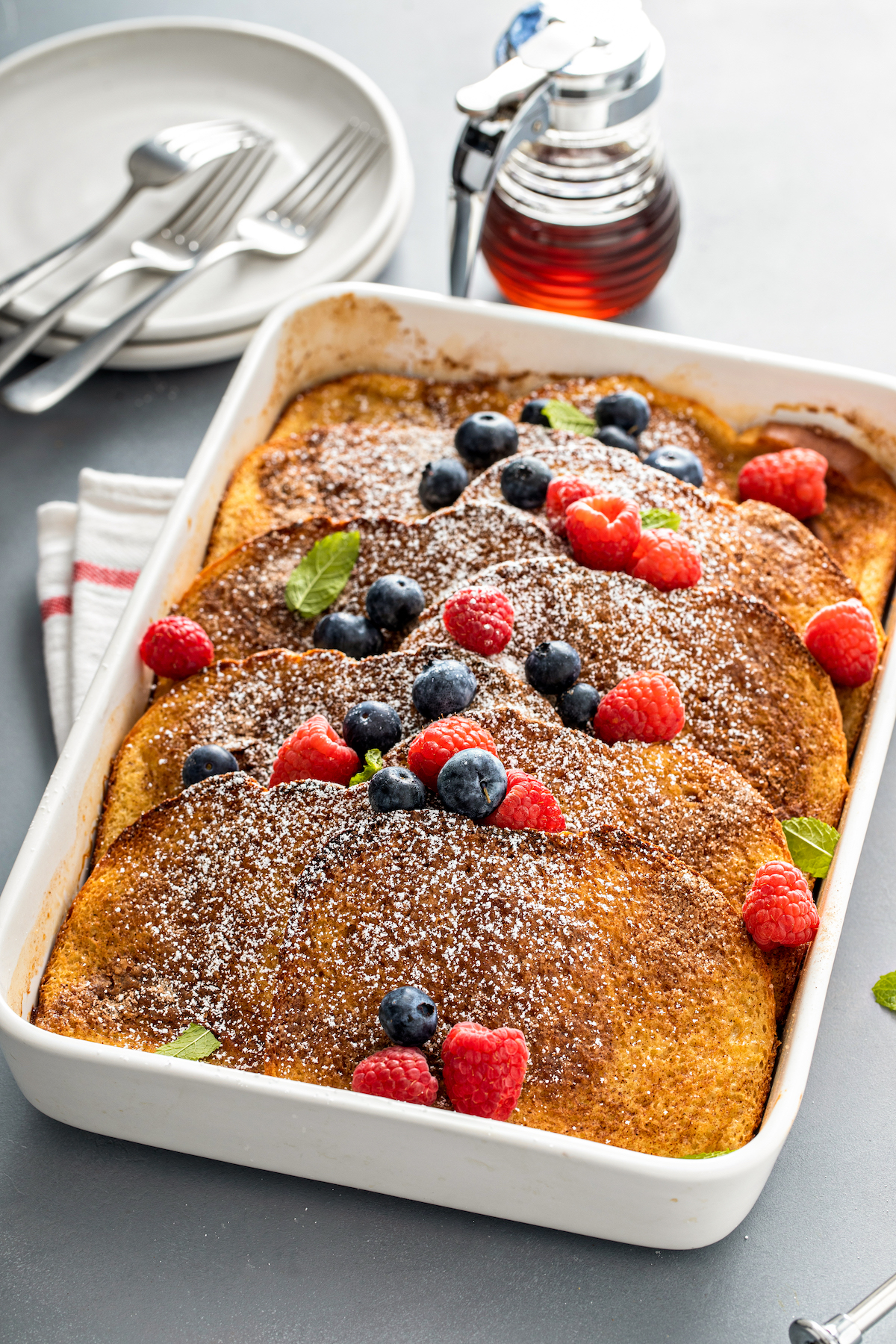 A French toast casserole topped with berries.