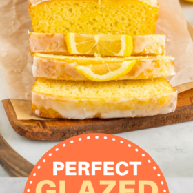 Glazed lemon loaf on a cutting board being sliced into pieces.