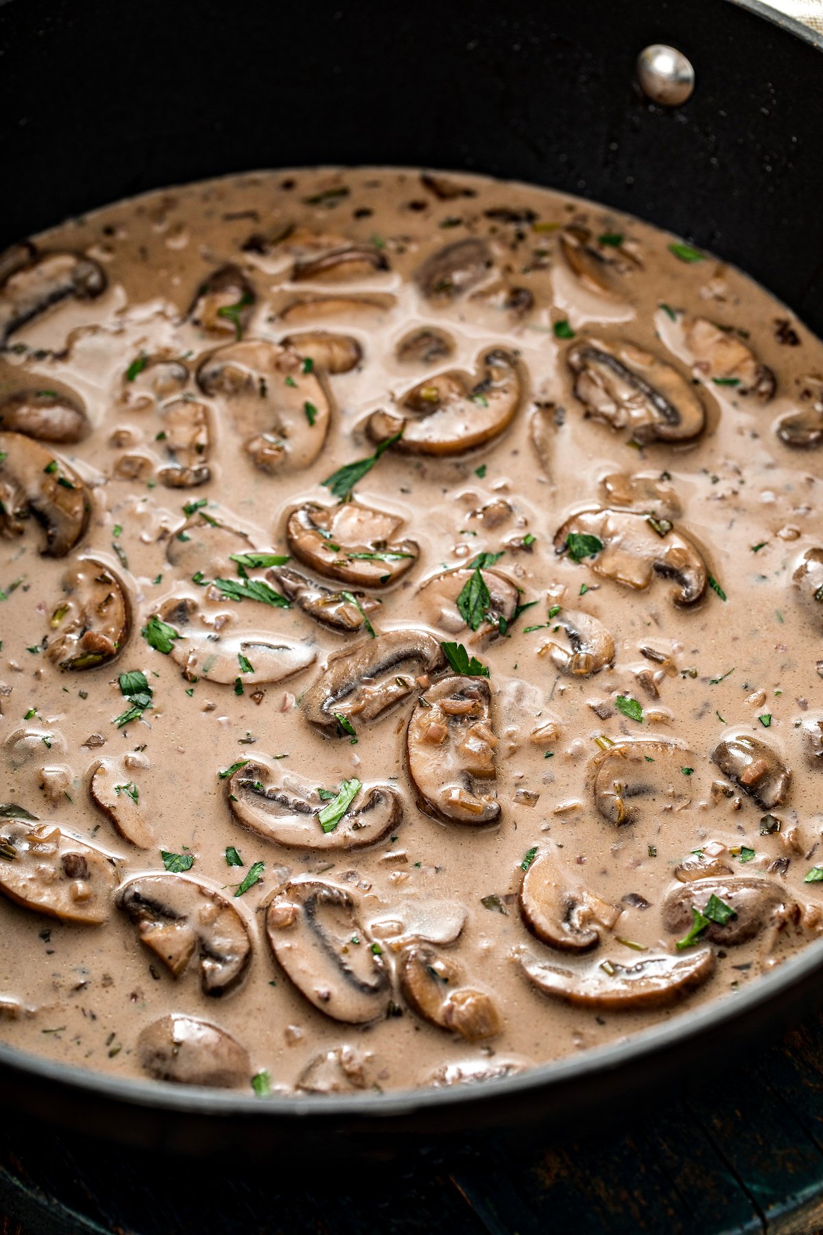 Mushroom sauce with parsley sprinkled over it.