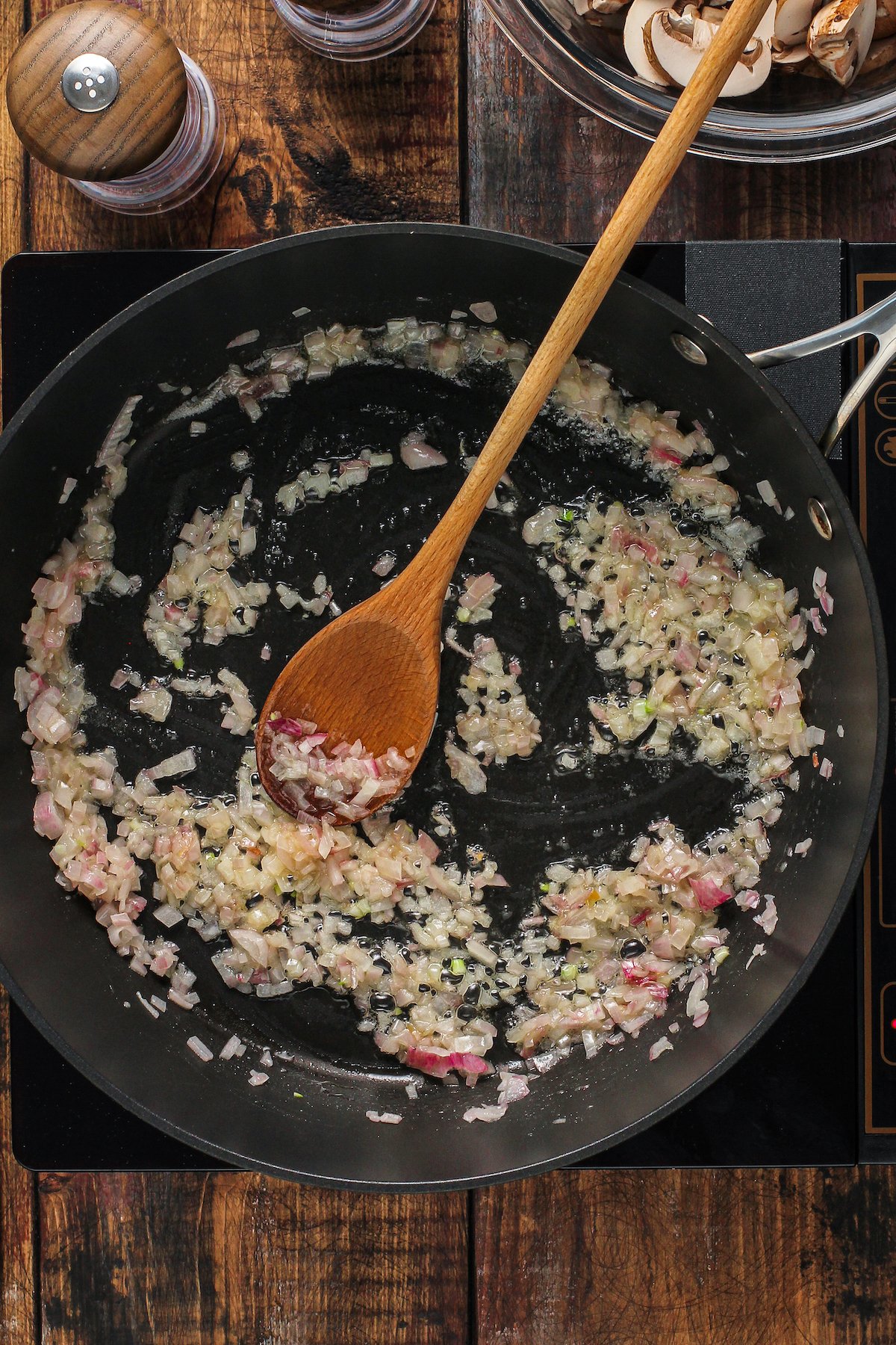 Shallots cooking in a pan.