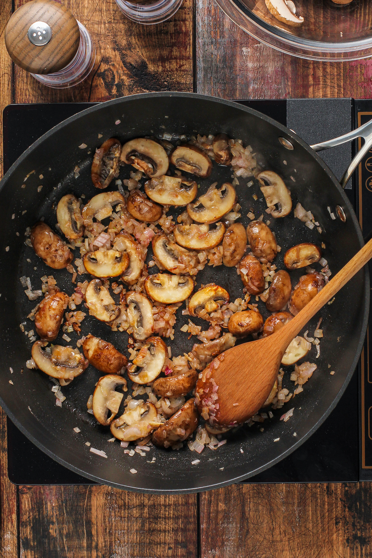 Mushrooms and shallots in a skillet.