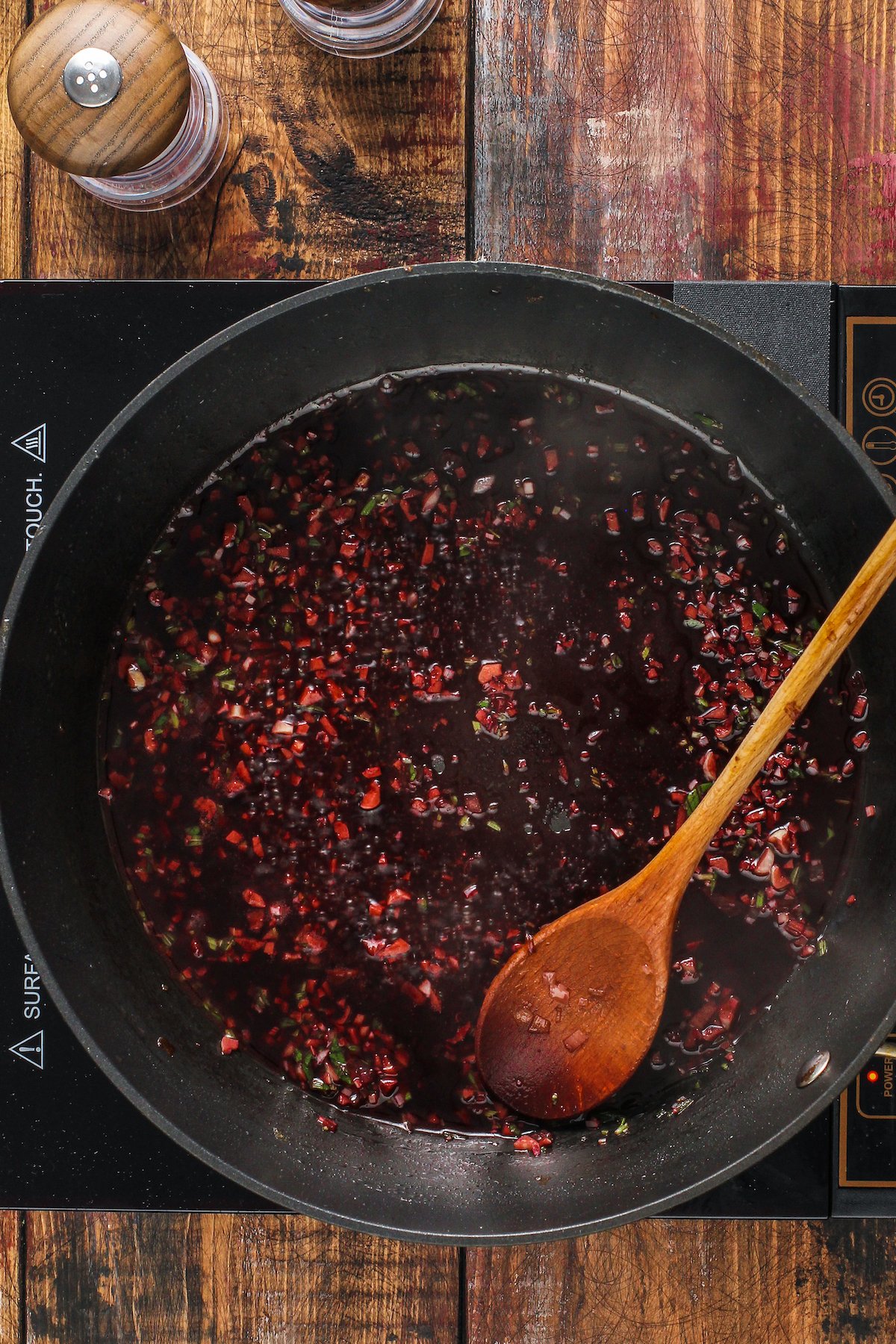 A skillet of simmering wine sauce.