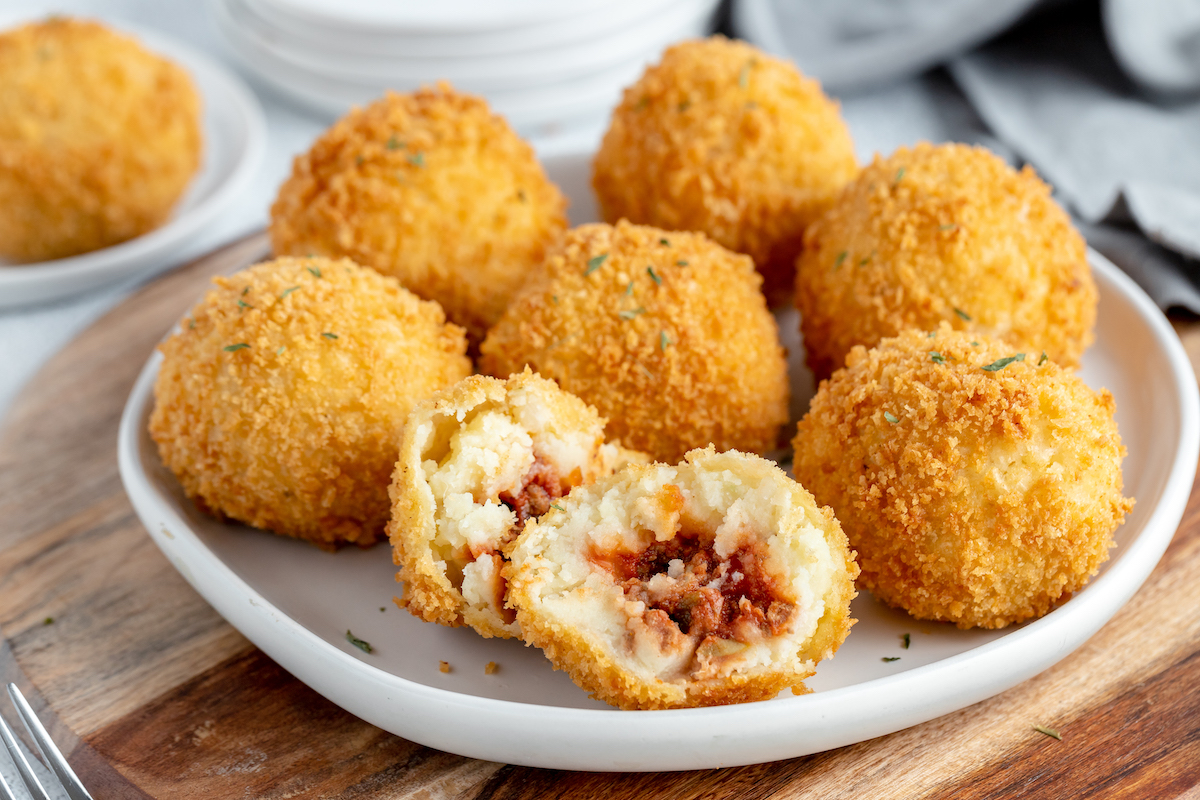 Mashed potato appetizers filled with beef picadillo.