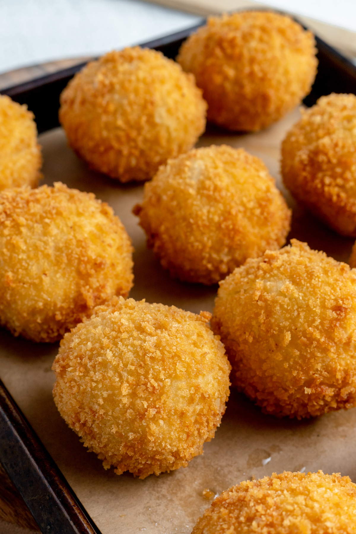 Close-up shot of the golden brown, breaded crust on papas rellenas.