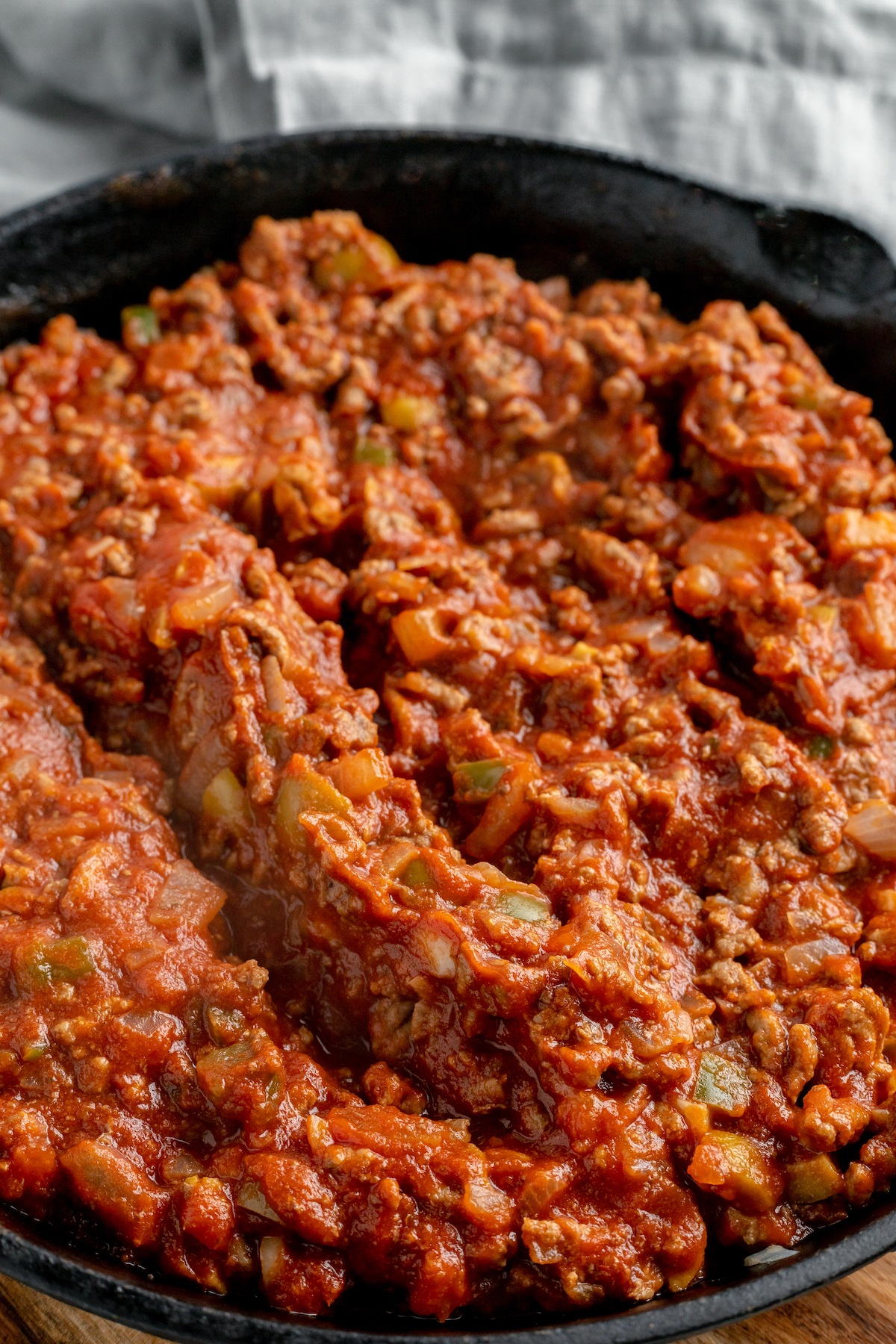 Beef picadillo with green olives in a skillet.