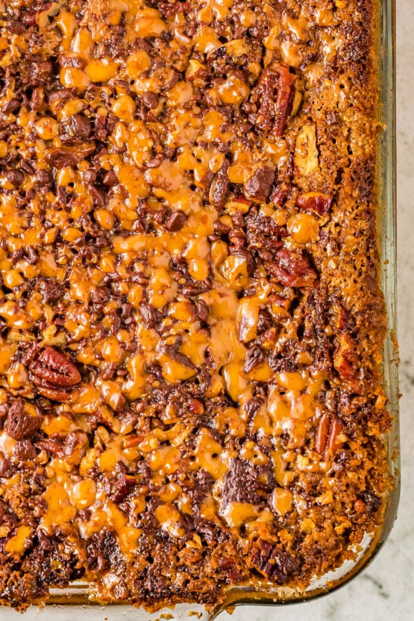 Close-up shot of the toffee and nut topping on the freshly baked pumpkin dump cake.