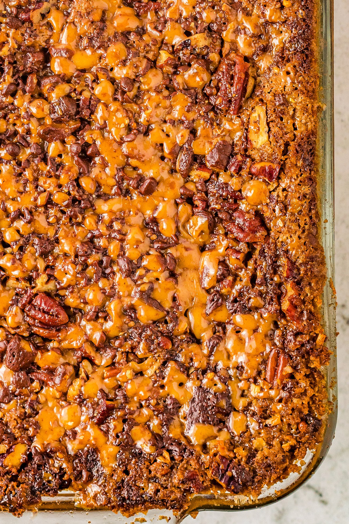 Close-up shot of dump cake topped with nuts and toffee.