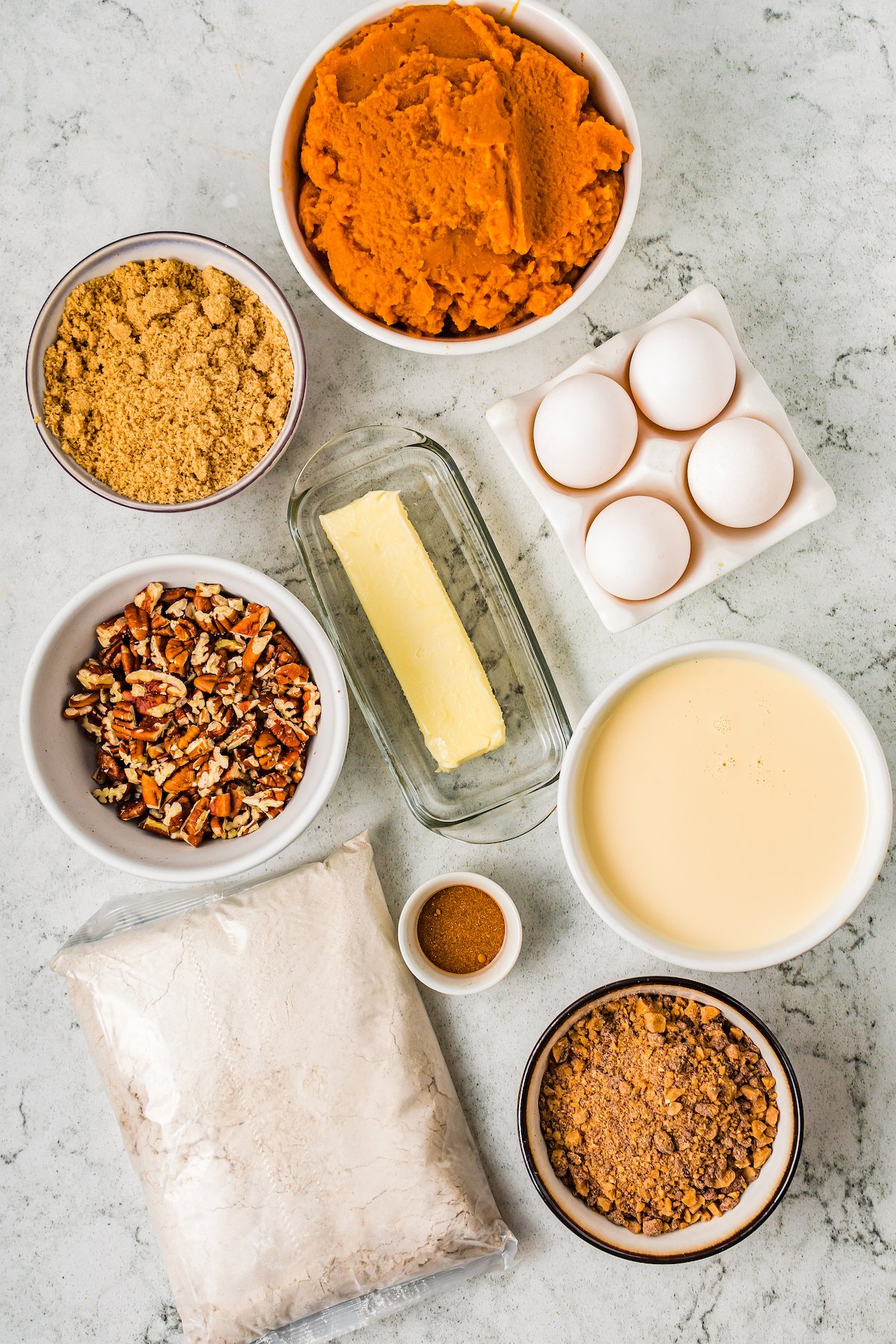 From top: Pumpkin puree, toffee pieces, butter, eggs, chopped pecans, evaporated milk, spices, cake mix, brown sugar.