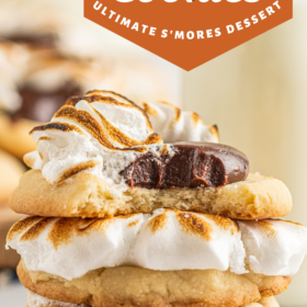 Smore's cookies stacked on top of each other with a bite taken out of the top cookie.