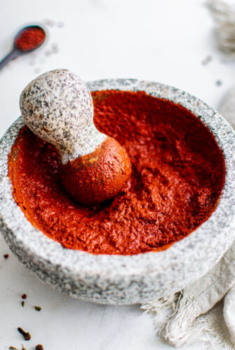 A spice-based red meat rub in a mortar and pestle