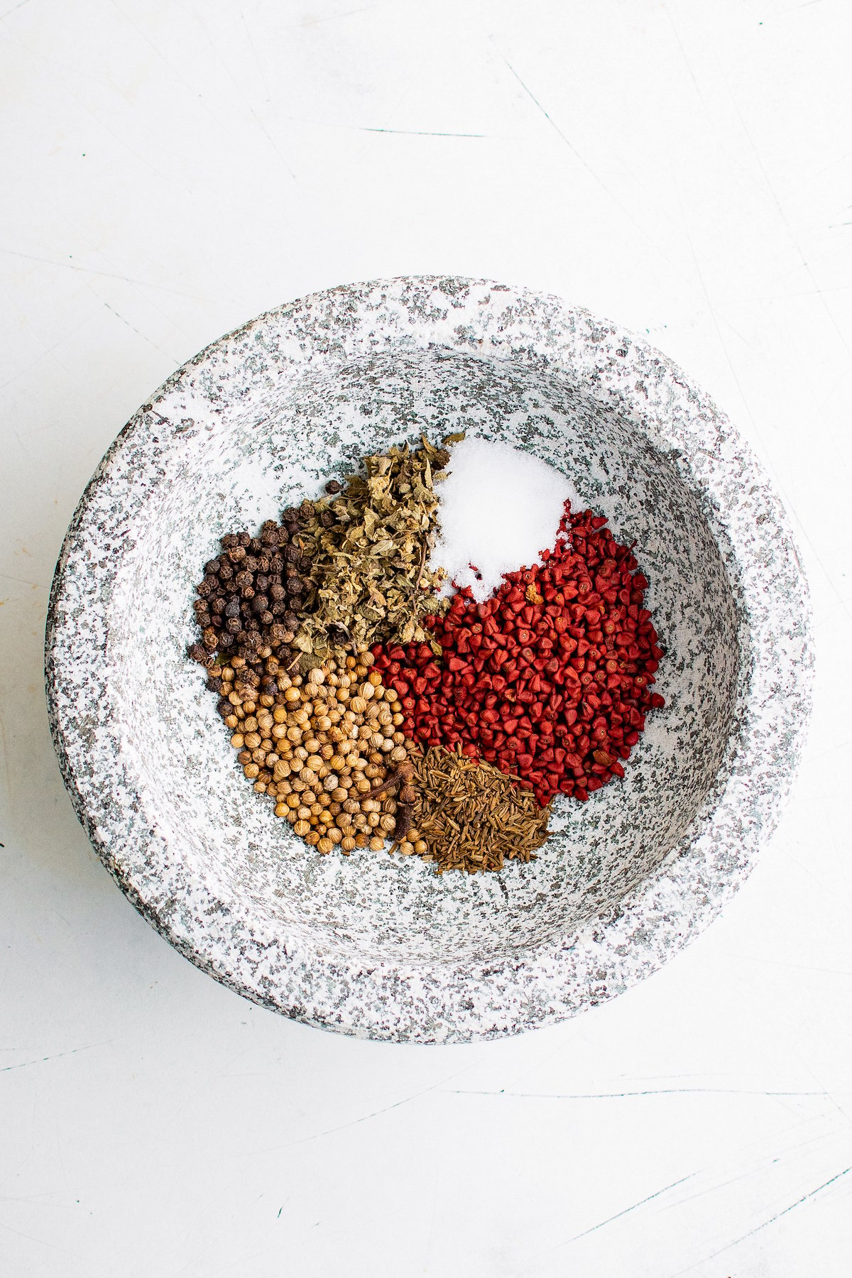 whole dried spices in a mortar and pestle