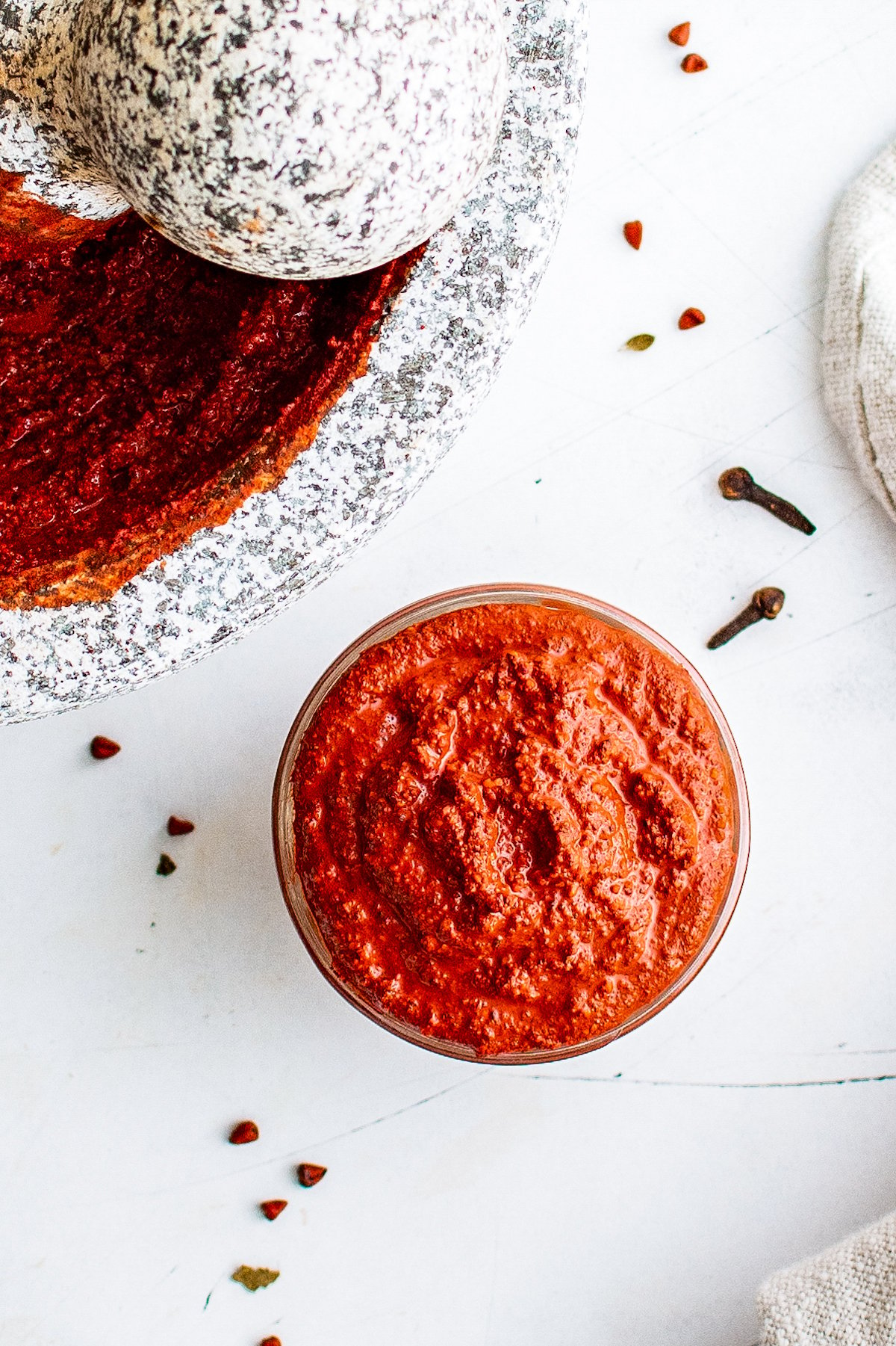 overhead view of a jar of red spice-based meat rub called achiote paste